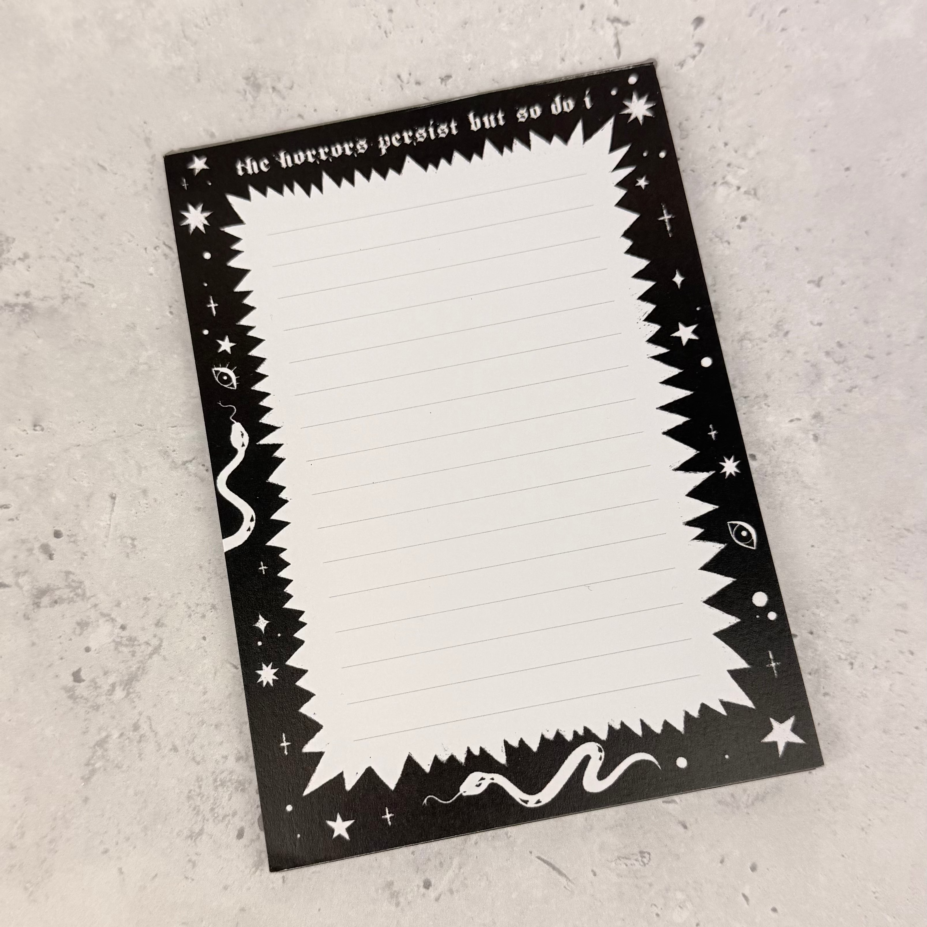 Black and white decorative card with text on a gray surface