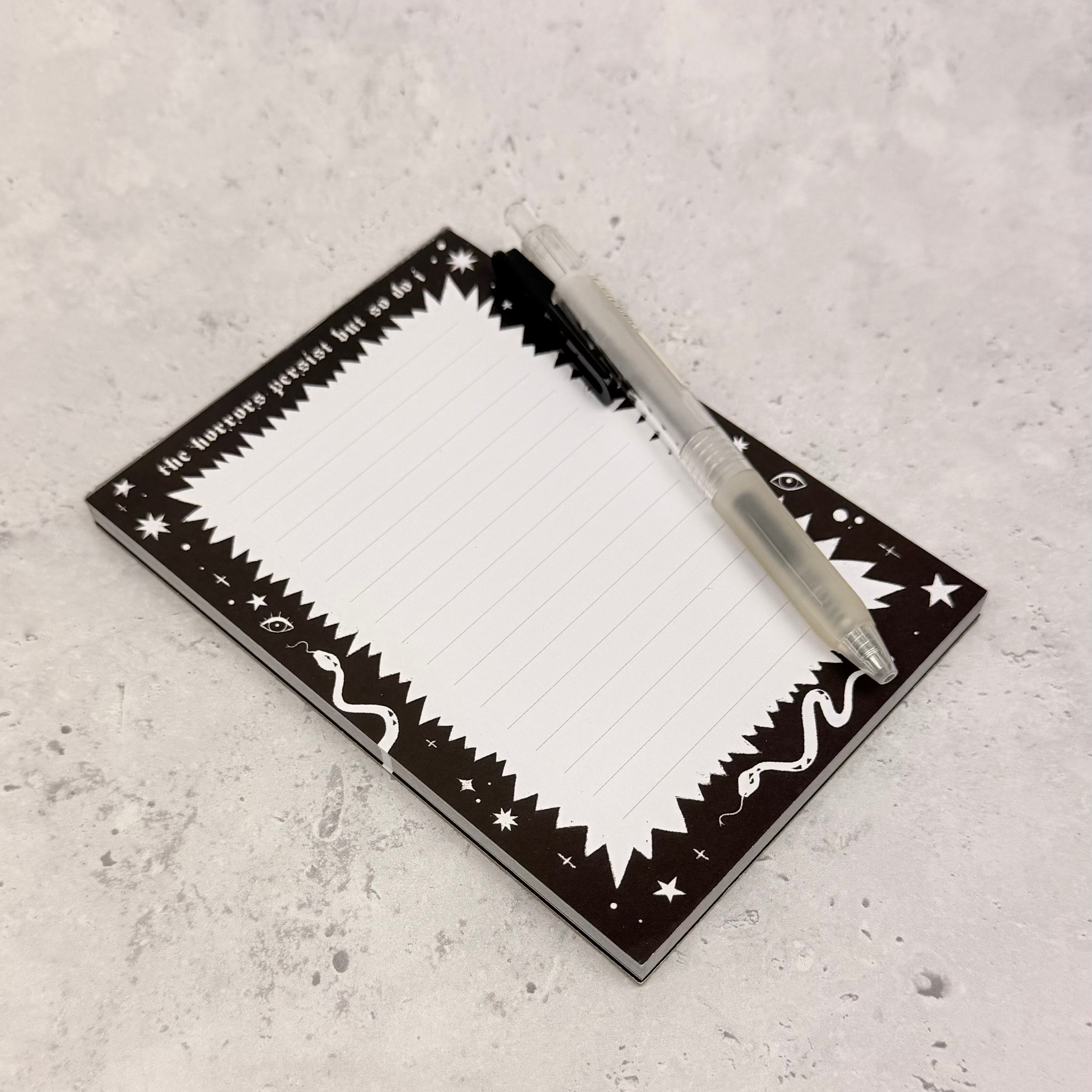 Rectangular mirror with decorative border on a textured gray surface