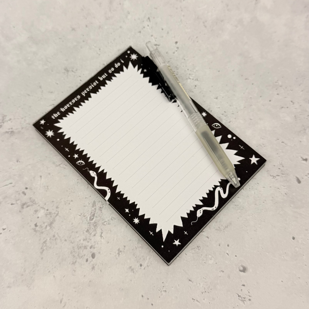 Rectangular white plate with black decorative border on a gray surface