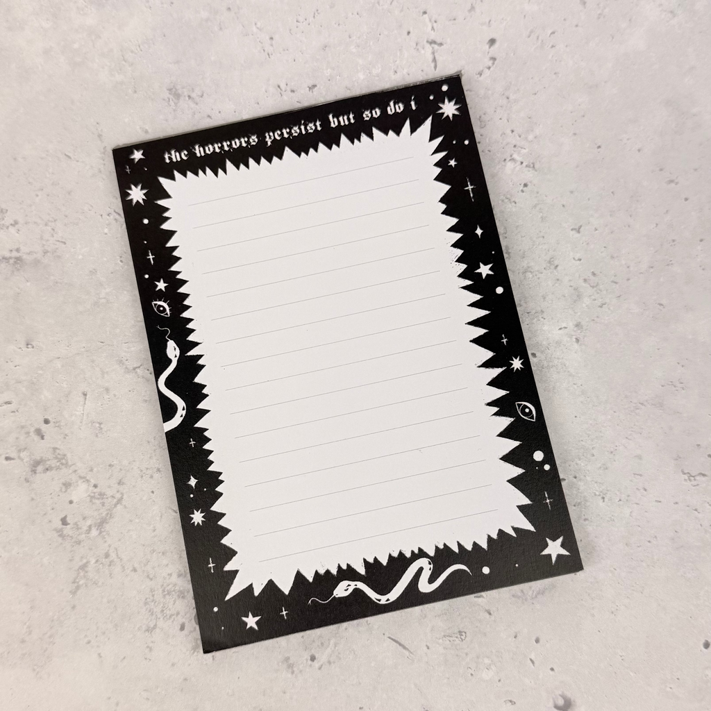 Black and white rectangular card with decorative border on a gray surface